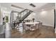 Elegant dining area with modern chandelier, table, and sophisticated seating adjacent to stairs at 1145 Kirkwood Se Ave # 4, Atlanta, GA 30316