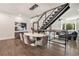 Elegant dining area with a modern staircase, pendant lighting, and seating for six people at 1145 Kirkwood Se Ave # 4, Atlanta, GA 30316
