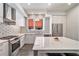 Stylish kitchen features stainless steel appliances, modern cabinetry, and tiled backsplash with a large island at 1145 Kirkwood Se Ave # 4, Atlanta, GA 30316