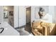 Cozy living room area with comfortable chair, modern art, and access to a half bathroom at 1145 Kirkwood Se Ave # 4, Atlanta, GA 30316
