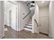 Modern stairwell with hardwood floors, white walls, and dark wood accents at 1145 Kirkwood Se Ave # 4, Atlanta, GA 30316