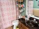 Functional bathroom featuring a toilet, patterned shower curtain, and wooden vanity with counter at 1554 Circlestone Dr, Stone Mountain, GA 30088