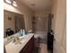 Bathroom featuring a vanity with sink, toilet, and shower-tub combination with neutral tile at 1554 Circlestone Dr, Stone Mountain, GA 30088