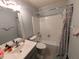Neat bathroom featuring a bath-shower combo, single sink vanity, and neutral decor at 1554 Circlestone Dr, Stone Mountain, GA 30088