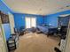 Cozy bedroom featuring bright blue walls, carpeted floors, and a window for natural light at 1554 Circlestone Dr, Stone Mountain, GA 30088