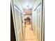 Hallway with closet space leading into kitchen with stainless steel appliances and tile flooring at 1554 Circlestone Dr, Stone Mountain, GA 30088
