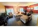 Spacious living room featuring hardwood floors, a large sectional sofa, and ample natural light at 1554 Circlestone Dr, Stone Mountain, GA 30088