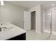 Bathroom with double sink vanity, tiled shower, and walk in closet at 706 Bristol Dr, Loganville, GA 30052