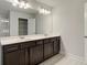 Bathroom featuring double sink vanity, storage, lighting and closet at 706 Bristol Dr, Loganville, GA 30052