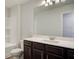 Bathroom with tub and shower combination and dark wood vanity with white sink at 706 Bristol Dr, Loganville, GA 30052