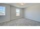 Light-filled bedroom with plush carpeting and bright windows at 706 Bristol Dr, Loganville, GA 30052