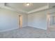 Bright bedroom features soft gray walls, plush carpeting, and a tray ceiling at 706 Bristol Dr, Loganville, GA 30052