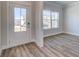 Bright entryway with wood-look flooring, a glass front door, and abundant natural light streaming through a window at 706 Bristol Dr, Loganville, GA 30052