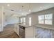 Open concept kitchen with center island, stainless dishwasher, and hardwood floors at 706 Bristol Dr, Loganville, GA 30052
