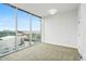 Well-lit room with large windows showcasing city views and carpeted flooring at 361 17Th Nw St # 922, Atlanta, GA 30363