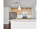 Open kitchen with stainless steel appliances, wood cabinets, and quartz countertops at 361 17Th Nw St # 922, Atlanta, GA 30363