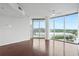 Bright living room with hardwood floors, ceiling fan, and sliding glass doors to balcony at 361 17Th Nw St # 922, Atlanta, GA 30363