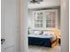 Comfortable bedroom with exposed brick, large window, and carpeted floor at 93 Peachtree Ne Pl # 5, Atlanta, GA 30309