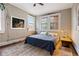 This cozy bedroom features exposed brick, a large window, and stylish rug at 93 Peachtree Ne Pl # 5, Atlanta, GA 30309