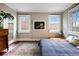 Bedroom featuring a large window, exposed brick, and hardwood floors at 93 Peachtree Ne Pl # 5, Atlanta, GA 30309