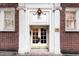 Classic brick building entrance featuring a secure glass paned doorway and stylish overhead lighting at 93 Peachtree Ne Pl # 5, Atlanta, GA 30309