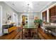 A modern dining room features a green table, designer lighting, and decor that enhance the room's aesthetic appeal at 93 Peachtree Ne Pl # 5, Atlanta, GA 30309