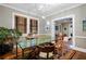 A sunlit dining room showcases a green table with seating, complemented by an adjacent living area for seamless entertaining at 93 Peachtree Ne Pl # 5, Atlanta, GA 30309