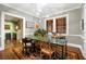 A spacious dining room features natural light, elegant decor, and a green table with seating for a comfortable and refined dining experience at 93 Peachtree Ne Pl # 5, Atlanta, GA 30309