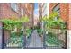 Charming garden entrance with a black metal gate and brick pathway, leading to a tranquil retreat at 93 Peachtree Ne Pl # 5, Atlanta, GA 30309