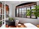 Sunroom featuring white brick walls, large window, and cozy seating area with decorative plant accents at 93 Peachtree Ne Pl # 5, Atlanta, GA 30309