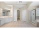 Bright bathroom featuring double sinks, a glass shower, and tile floors at 4085 Creekview Ridge Dr, Buford, GA 30518