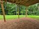 A serene view from the back porch overlooks a lush green yard and wooded area at 508 Clayborne Way, Loganville, GA 30052
