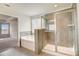 Bathroom featuring a soaking tub and glass enclosed shower with tile surround at 508 Clayborne Way, Loganville, GA 30052