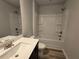 Bathroom showcasing vanity, toilet, tub and shower combination with white fixtures at 508 Clayborne Way, Loganville, GA 30052