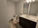 Bathroom featuring tile floors, a modern vanity with dark wood cabinets, and white sink at 508 Clayborne Way, Loganville, GA 30052