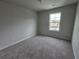 Cozy bedroom with plush carpet and ample natural light from the window at 508 Clayborne Way, Loganville, GA 30052