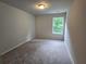 Bedroom featuring neutral carpet and natural light from a single window at 508 Clayborne Way, Loganville, GA 30052