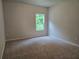 Cozy bedroom with neutral carpeting and a bright window at 508 Clayborne Way, Loganville, GA 30052
