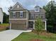 Charming two-story home with brick and siding, attached garage and beautiful landscaping at 508 Clayborne Way, Loganville, GA 30052
