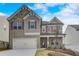 Charming two-story home with brick and stone accents, attached two-car garage, and manicured front yard at 508 Clayborne Way, Loganville, GA 30052