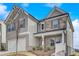 Charming two-story home with brick and stone accents, attached two-car garage, and a welcoming front porch at 508 Clayborne Way, Loganville, GA 30052