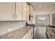 Kitchen with granite countertops, stainless steel appliances, and tile backsplash at 508 Clayborne Way, Loganville, GA 30052