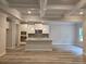 Bright kitchen with white cabinets, an island with granite countertops and stainless-steel appliances at 508 Clayborne Way, Loganville, GA 30052