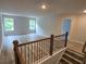 Bright living room featuring wood floors, neutral walls, and natural light from two windows at 508 Clayborne Way, Loganville, GA 30052