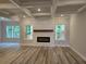 Spacious living room with coffered ceiling, fireplace, and natural light at 508 Clayborne Way, Loganville, GA 30052