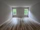 Bright living room featuring wood floors, neutral walls, and natural light from two windows at 508 Clayborne Way, Loganville, GA 30052