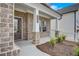 Welcoming front porch with stone-accented pillars and manicured landscaping leading to the front door at 508 Clayborne Way, Loganville, GA 30052