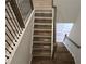 Staircase with wooden steps, wooden railings and black metal spindles at 508 Clayborne Way, Loganville, GA 30052