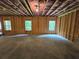 Large unfinished room with exposed framing, windows, and overhead lighting at 508 Clayborne Way, Loganville, GA 30052