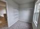 Walk-in closet with carpet, wire shelving and a view of the Primary bathroom at 508 Clayborne Way, Loganville, GA 30052